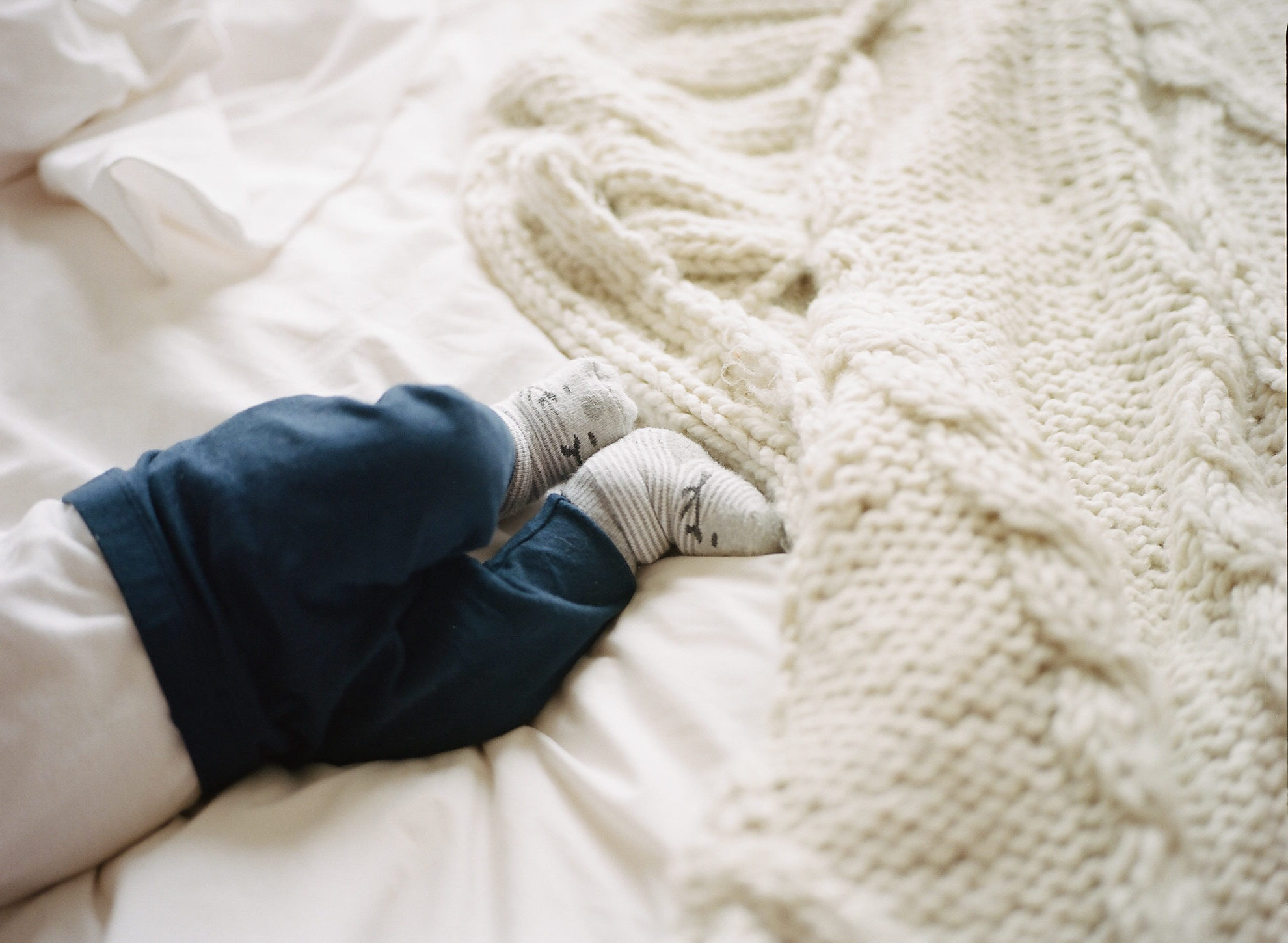 Baby on a bed | Batelle